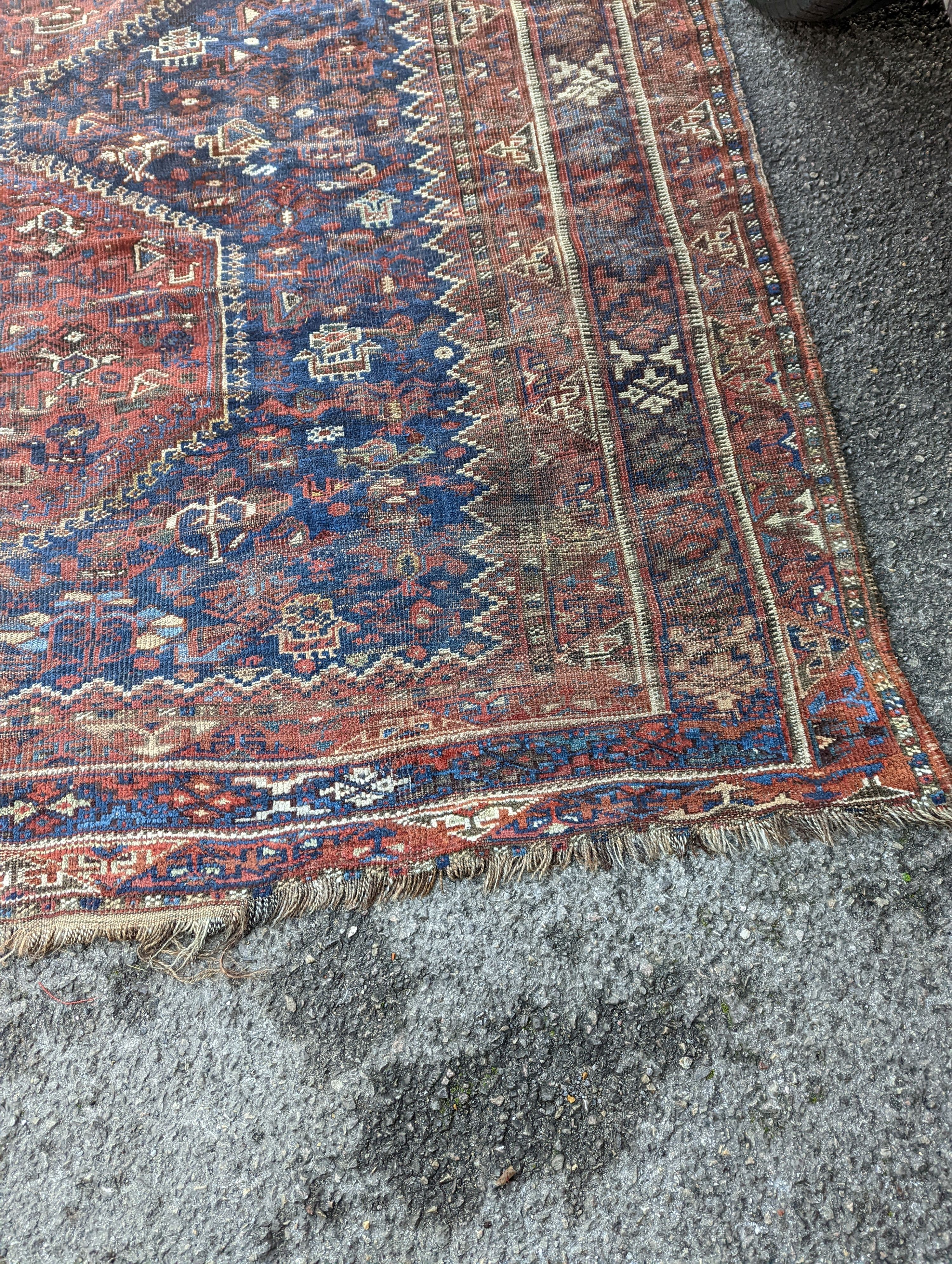 An antique Shirvan red ground carpet (worn), 295 x 207cm